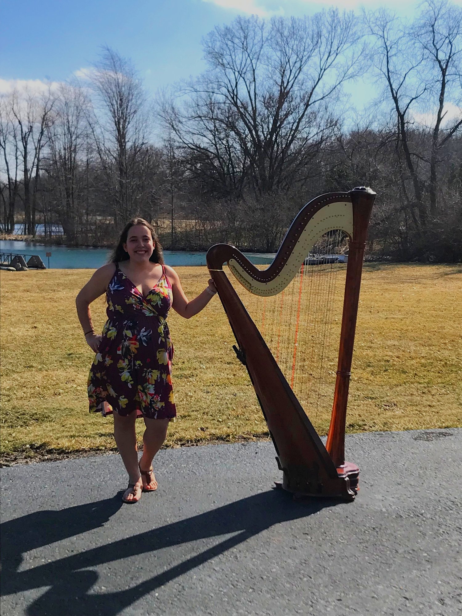 Maia posing with her Harp.  Outdoors for for a late fall wedding in Central Indiana. 